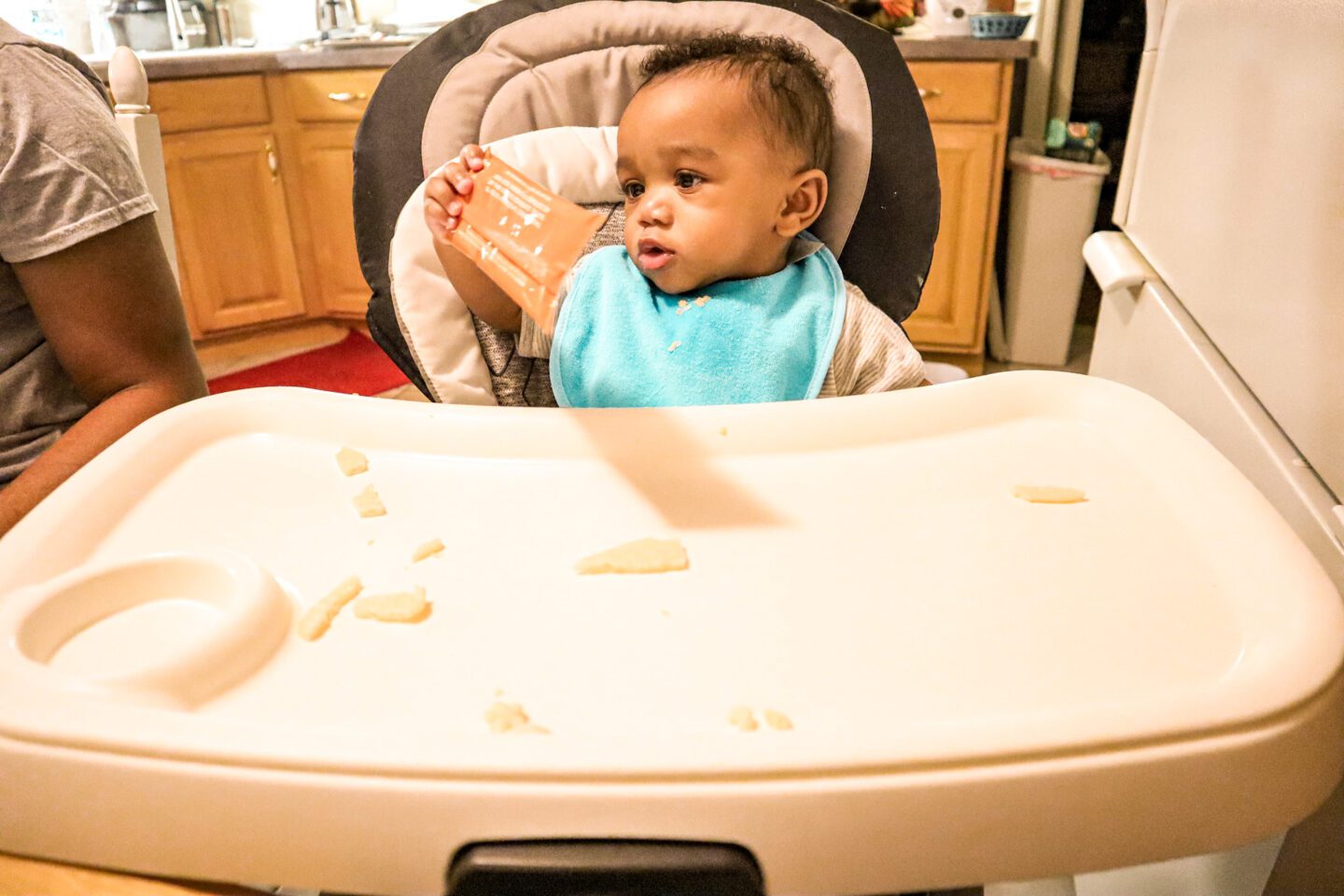 raise a child in the chair at the dinner table